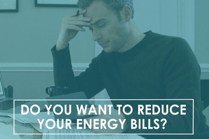 Do You Want to Reduce Your Energy Bills? Image shows man sitting at table and looking at check book.